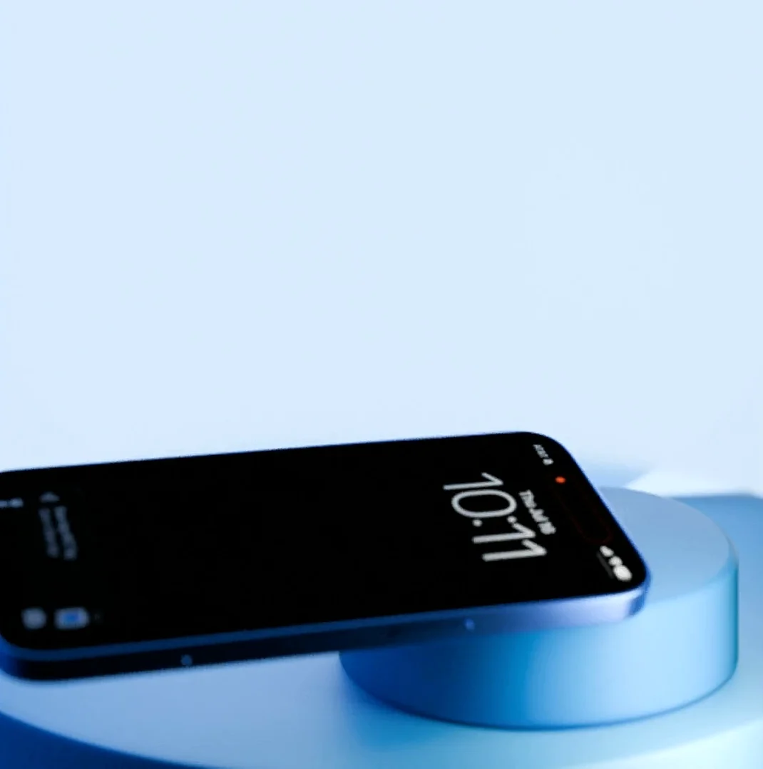 A phone lying flat on the disc of the CrypTap terminal.